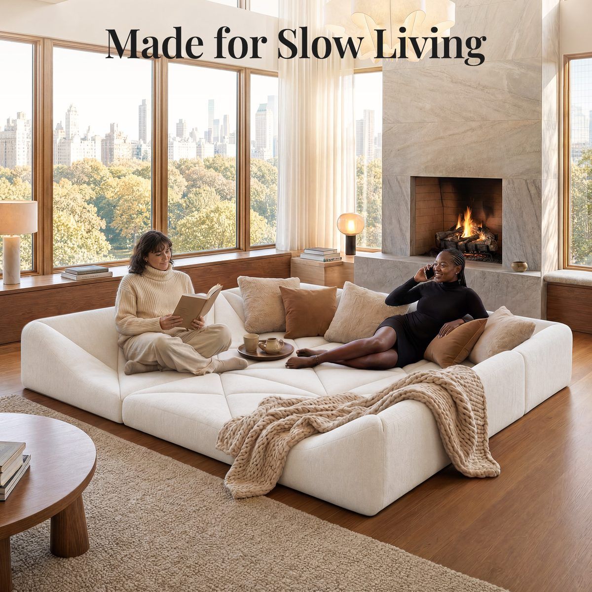 White Dune modular sofa square-pit sectional styled by a fireplace with skyline view and throws