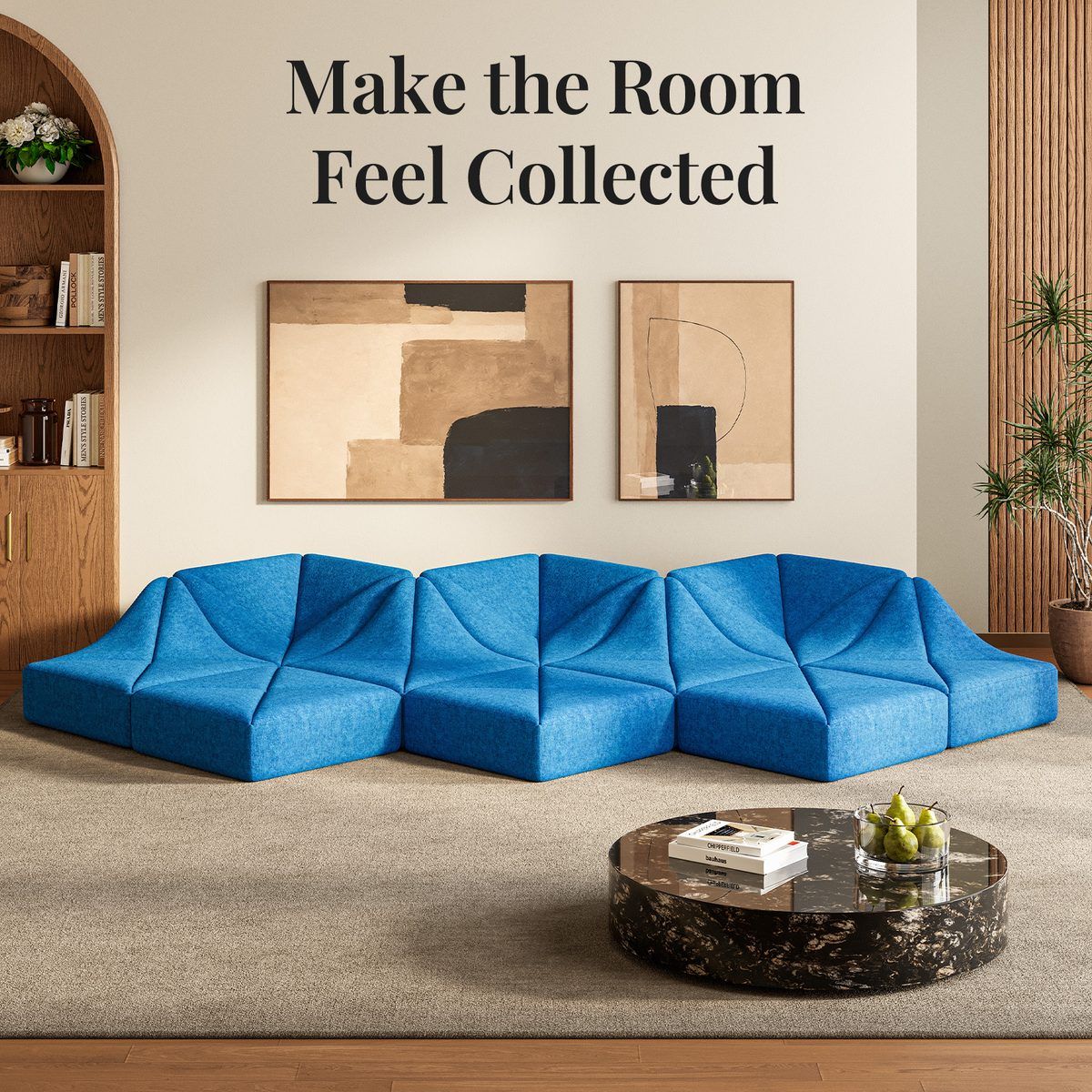 Blue Dune modular sofa wave layout beneath framed abstract art in a warm, curated living room