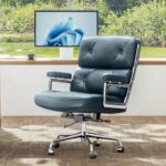Dark Blue Eames Executive Office Chair beside a desk overlooking a garden pond.