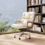 Ivory White Eames Executive Office Chair beside a bookcase and a large window.