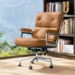 Light Brown Eames Executive Office Chair beside a bookcase and a large window.