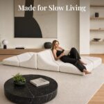 White Dune daybed sofa in a living room with a woman reclining against the peaked backrest