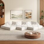 White Dune modular sofa wave layout in a bright neutral living room with framed wall art